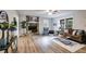 Bright living room with hardwood floors, stone fireplace, and modern furnishings at 10213 Tall Pine Ct, Villa Rica, GA 30180