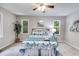 A comfortable bedroom offers a ceiling fan and large windows at 10213 Tall Pine Ct, Villa Rica, GA 30180