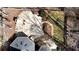 Aerial view of the home with a stone patio, outdoor fireplace, and fire pit at 3290 Coachmans Ne Way, Roswell, GA 30075