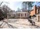 Spacious backyard features a stone patio, outdoor fireplace, and brick home exterior at 3290 Coachmans Ne Way, Roswell, GA 30075