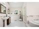 Bathroom boasts double sinks, soaking tub and tiled floor at 3290 Coachmans Ne Way, Roswell, GA 30075