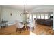 Dining area adjacent to the living room features a chandelier and a glass top table at 3290 Coachmans Ne Way, Roswell, GA 30075