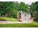 Stunning brick home boasts a stone entryway, two-car garage, and lush green lawn at 3290 Coachmans Ne Way, Roswell, GA 30075