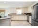 Kitchen featuring stainless steel appliances, white cabinets, and tile floors at 3290 Coachmans Ne Way, Roswell, GA 30075