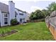 Fenced-in backyard featuring a patio area and green lawn perfect for outdoor enjoyment at 566 Lullingstone Se Dr, Marietta, GA 30067