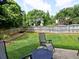 Backyard features a patio with outdoor seating, lush green grass, and a wood fence at 566 Lullingstone Se Dr, Marietta, GA 30067