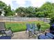Spacious backyard with green lawn, a patio, a wooden fence and lush landscaping at 566 Lullingstone Se Dr, Marietta, GA 30067