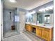 Modern bathroom featuring double sinks, a walk-in shower with glass doors, and ample vanity space at 566 Lullingstone Se Dr, Marietta, GA 30067