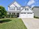 Beautiful two-story home with a well-maintained lawn, a two-car garage and a cozy front porch at 566 Lullingstone Se Dr, Marietta, GA 30067