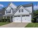 A two-story home with gray siding features an attached two-car garage and a well-manicured lawn at 566 Lullingstone Se Dr, Marietta, GA 30067