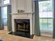 Close-up of the fireplace with decorative mantel, flanked by windows and curtains at 566 Lullingstone Se Dr, Marietta, GA 30067