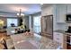 Spacious kitchen with stainless steel refrigerator, granite countertops, and open view to dining and living spaces at 566 Lullingstone Se Dr, Marietta, GA 30067