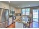 Modern kitchen with stainless steel appliances, granite countertops, white cabinets, and a breakfast bar at 566 Lullingstone Se Dr, Marietta, GA 30067