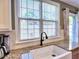 Close-up of a kitchen sink with a view of the window and granite countertops at 566 Lullingstone Se Dr, Marietta, GA 30067