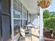 Inviting front porch with seating and decorative hanging plants, perfect for enjoying the outdoors at 566 Lullingstone Se Dr, Marietta, GA 30067