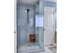 Beautifully tiled walk-in shower with glass doors and a pebble floor design, offering a luxurious spa-like experience at 566 Lullingstone Se Dr, Marietta, GA 30067
