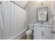 Full bathroom featuring a tub with a shower, vanity, and a large mirror at 580 Cliftwood Ct, Sandy Springs, GA 30328