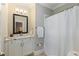 Traditional bathroom with a white vanity, framed mirror, and shower with curtain at 580 Cliftwood Ct, Sandy Springs, GA 30328
