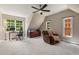 Spacious bedroom with natural light, a ceiling fan, and a comfortable chair at 580 Cliftwood Ct, Sandy Springs, GA 30328