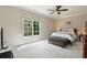 Bright bedroom with neutral tones, large window, ceiling fan and comfortable furnishings at 580 Cliftwood Ct, Sandy Springs, GA 30328