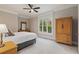Spacious bedroom with plush carpet, a ceiling fan, natural light, and a closet at 580 Cliftwood Ct, Sandy Springs, GA 30328