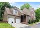 Stunning home with a two-car garage, stylish siding, and brick accents, enhancing its architectural charm and curb appeal at 580 Cliftwood Ct, Sandy Springs, GA 30328