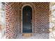 Elegant front door with stone and brick details, creating a grand entrance to the home at 580 Cliftwood Ct, Sandy Springs, GA 30328