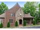Inviting brick home with a stone entrance, complemented by manicured shrubs, offering a timeless and sophisticated appeal at 580 Cliftwood Ct, Sandy Springs, GA 30328
