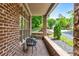 Cozy front porch with brick flooring and comfortable seating, perfect for relaxing and enjoying the peaceful surroundings at 580 Cliftwood Ct, Sandy Springs, GA 30328