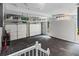 Spacious garage with storage racks, two white garage doors, and a convenient side entrance at 580 Cliftwood Ct, Sandy Springs, GA 30328