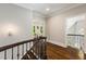 Bright hallway with hardwood floors and detailed trim, leading to a seating area and staircase at 580 Cliftwood Ct, Sandy Springs, GA 30328