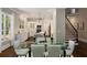 Bright kitchen and breakfast nook features white cabinets, marble countertops, and an adjacent staircase at 580 Cliftwood Ct, Sandy Springs, GA 30328