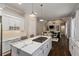 Open kitchen with stainless appliances, marble countertops, white cabinets, island and views of the living area at 580 Cliftwood Ct, Sandy Springs, GA 30328