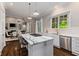 Gourmet kitchen flows into the living area, complete with marble counters, island, and stainless appliances at 580 Cliftwood Ct, Sandy Springs, GA 30328