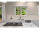 Close up of a kitchen with granite countertops, stainless steel appliances, and a view through the window at 580 Cliftwood Ct, Sandy Springs, GA 30328
