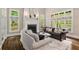 Bright and airy living room with a fireplace, large windows, and stylish furnishings, perfect for relaxation at 580 Cliftwood Ct, Sandy Springs, GA 30328