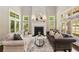 Bright living room features fireplace, large windows, and neutral decor at 580 Cliftwood Ct, Sandy Springs, GA 30328