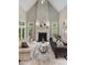 Bright living room features fireplace, large windows, and neutral decor at 580 Cliftwood Ct, Sandy Springs, GA 30328