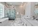 Luxurious bathroom featuring marble accents, a freestanding tub, glass shower, and dual vanities at 580 Cliftwood Ct, Sandy Springs, GA 30328