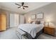 Bright main bedroom boasts a plush bed, nightstands, seating, ceiling fan, and ensuite bathroom at 580 Cliftwood Ct, Sandy Springs, GA 30328