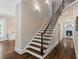 Staircase with dark wood steps and white risers, leading to a bright living area at 580 Cliftwood Ct, Sandy Springs, GA 30328
