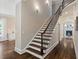 Elegant staircase with wood treads, iron railings, and high ceilings at 580 Cliftwood Ct, Sandy Springs, GA 30328