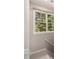 Bright landing with large window, offering a view of lush greenery at 580 Cliftwood Ct, Sandy Springs, GA 30328