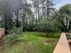 An expansive backyard with lush greenery, mature trees, and a partial view of a wood fence at 910 Oriole Se Ln, Marietta, GA 30067