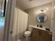 Bathroom with modern vanity, round mirror, and patterned shower curtain at 910 Oriole Se Ln, Marietta, GA 30067