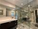 Modern bathroom featuring marble floors, glass shower, and sleek vanity at 910 Oriole Se Ln, Marietta, GA 30067