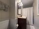 Cozy bathroom featuring a vanity and shower with white beadboard at 910 Oriole Se Ln, Marietta, GA 30067