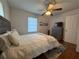 Bedroom featuring a ceiling fan, three-drawer dresser and wood floors at 910 Oriole Se Ln, Marietta, GA 30067