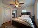 Bedroom featuring a ceiling fan, mirrored closet door and wood floors at 910 Oriole Se Ln, Marietta, GA 30067