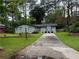 Inviting single-story home with a spacious driveway and lush landscaping at 910 Oriole Se Ln, Marietta, GA 30067
